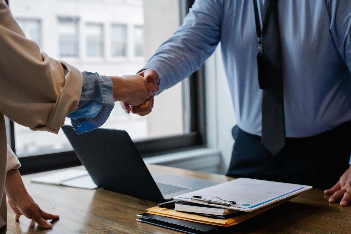 Handshake over a table of contract documents